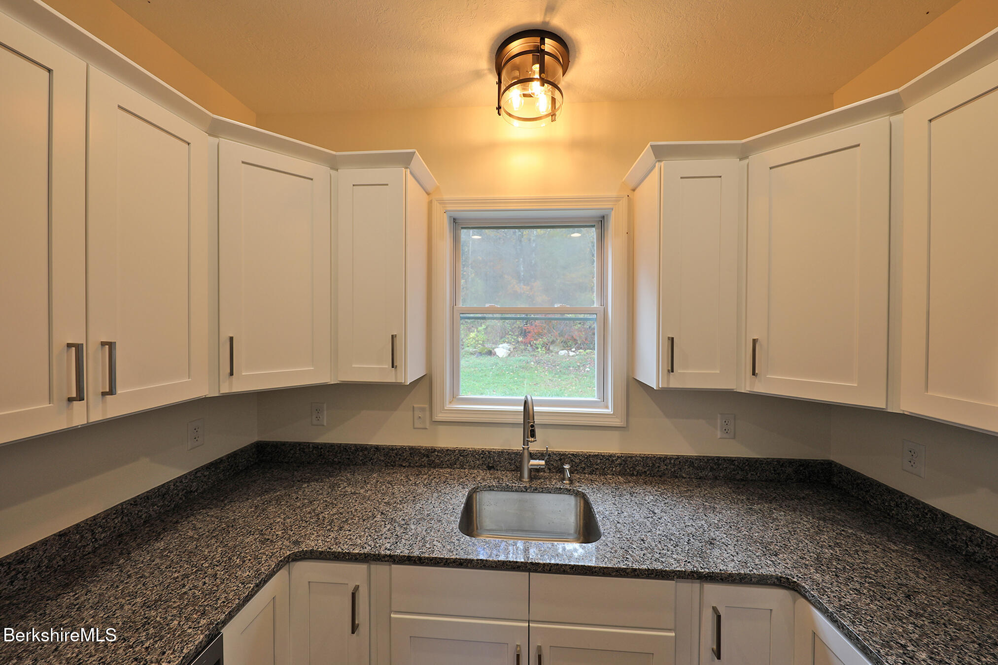 165 Sandisfield Road Sandisfield, MA 01255 - Photo 13 of 49 a kitchen with granite countertop a sink and white cabinets
