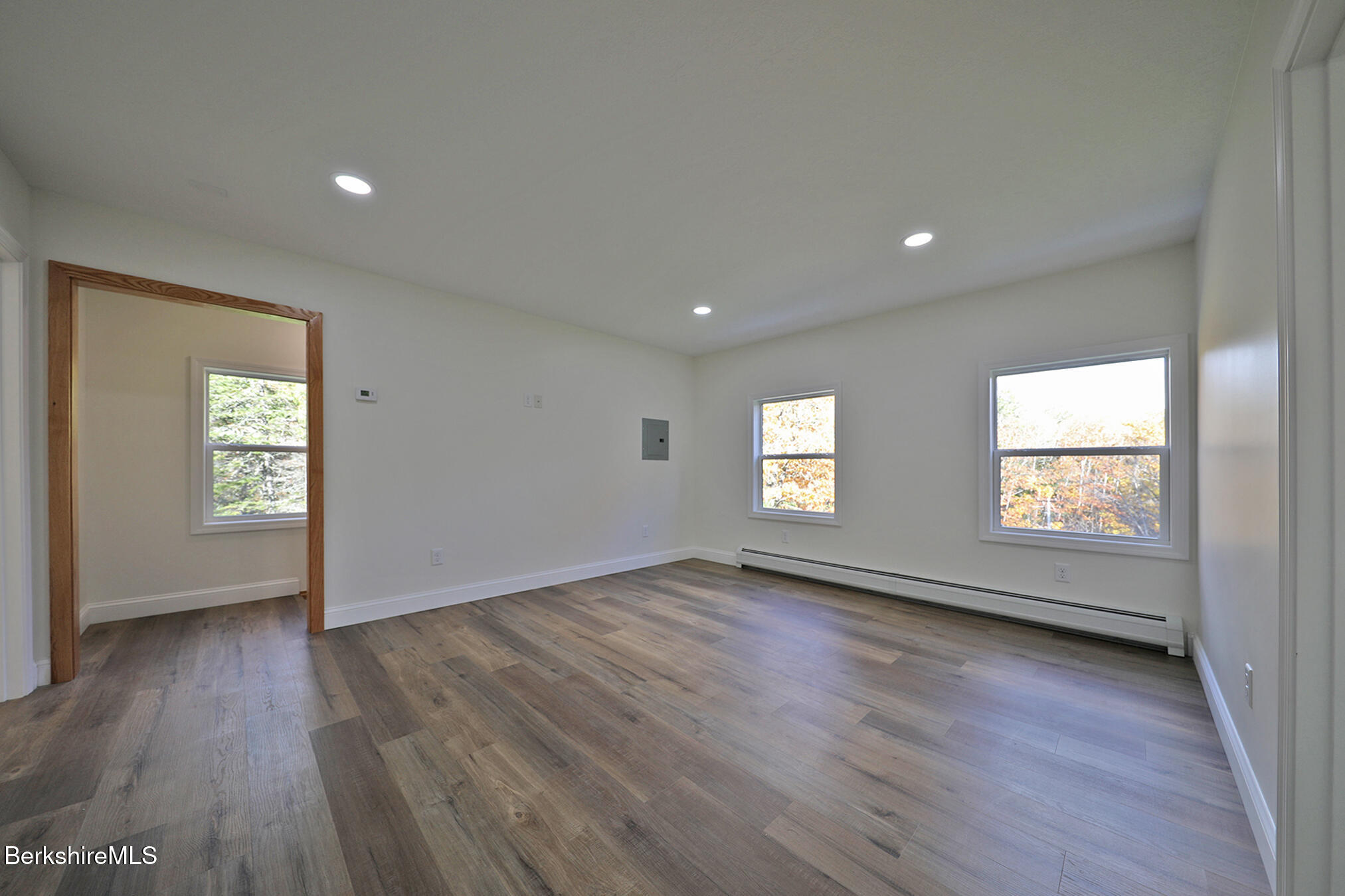 165 Sandisfield Road Sandisfield, MA 01255 - Photo 27 of 49 an empty room with wooden floor and windows