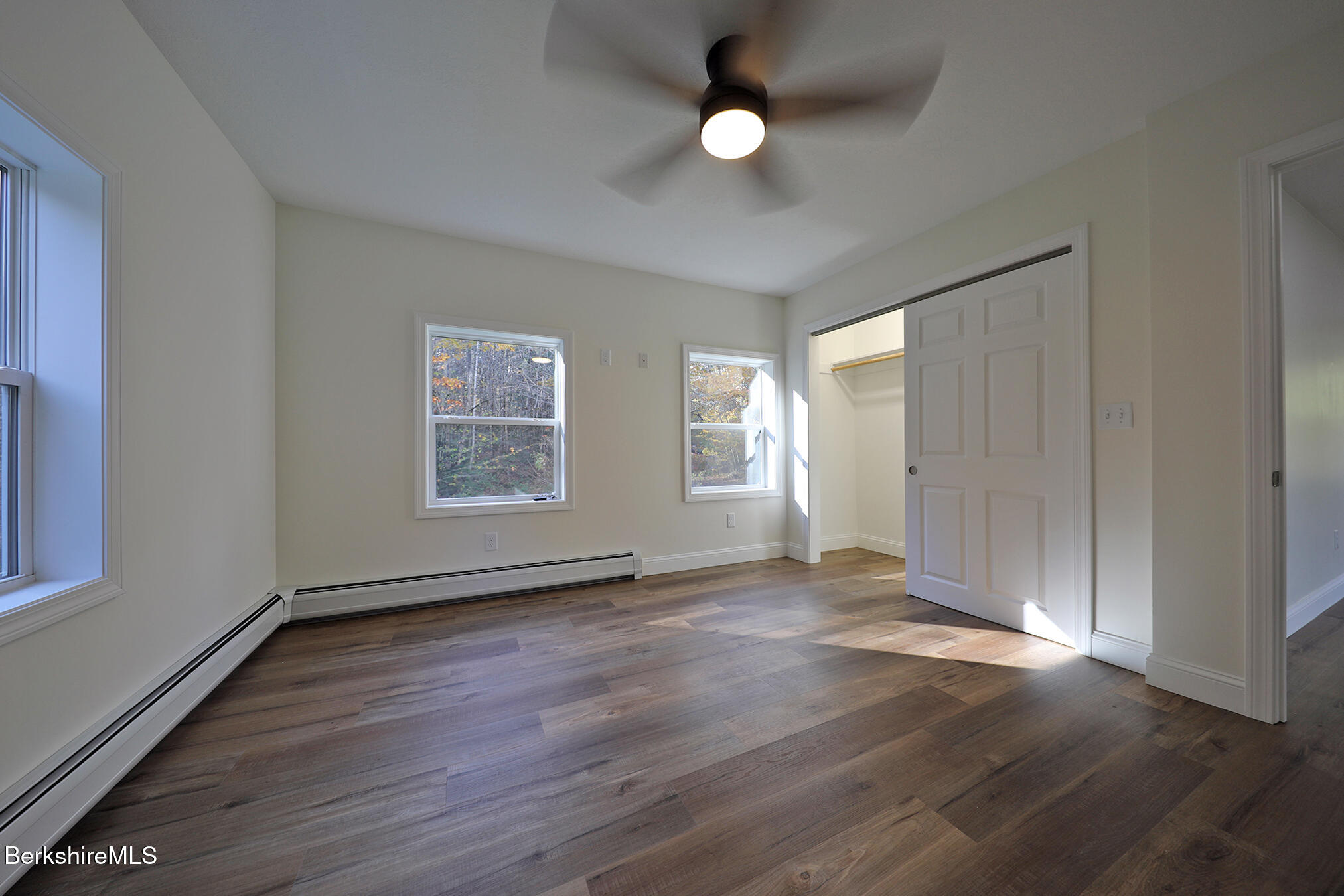 165 Sandisfield Road Sandisfield, MA 01255 - Photo 35 of 49 an empty room with wooden floor and windows