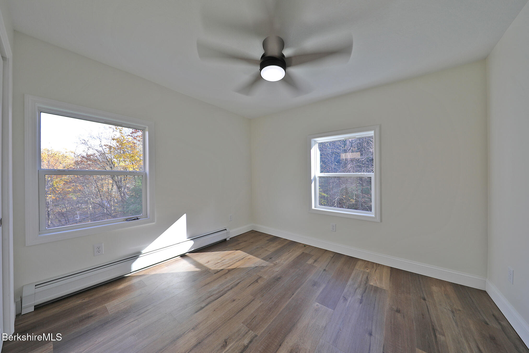 165 Sandisfield Road Sandisfield, MA 01255 - Photo 36 of 49 a view of an empty room with wooden floor and a window