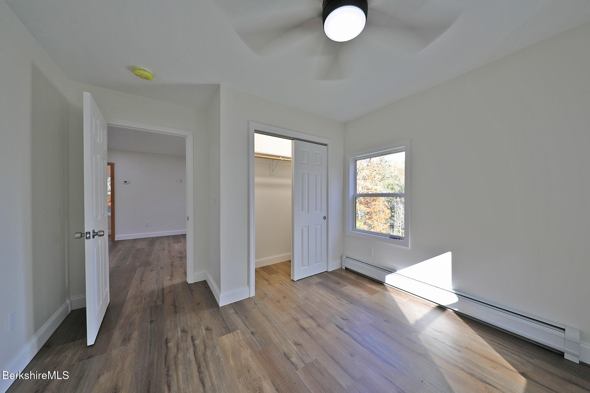 165 Sandisfield Road Sandisfield, MA 01255 - Photo 37 of 49 a view of empty room with wooden floor and fan