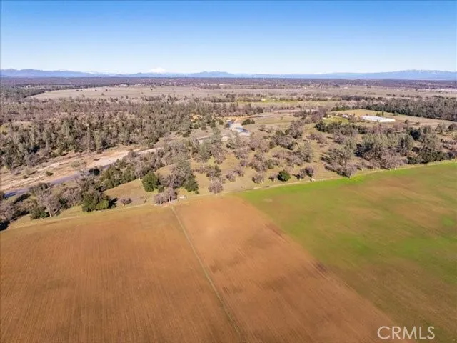 an aerial view of ocean and residential houses with outdoor space