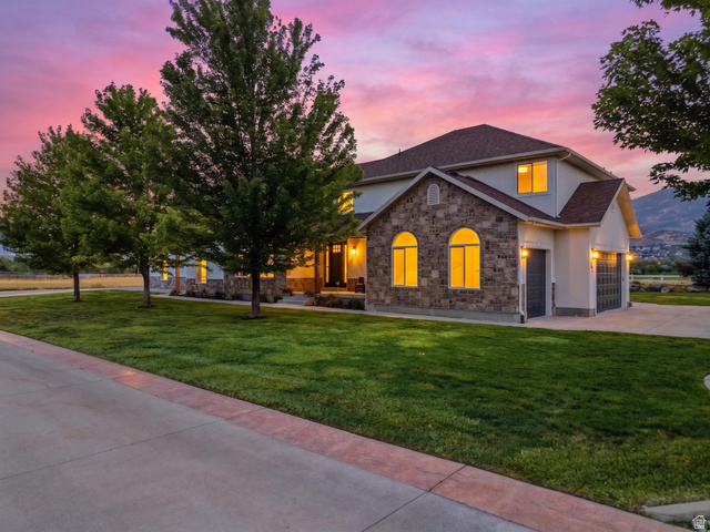 702 Alpine Highway Alpine, UT 84004 - Photo 2 of 83 Stately exterior featuring stone accents, arched windows, and a multi-car garage