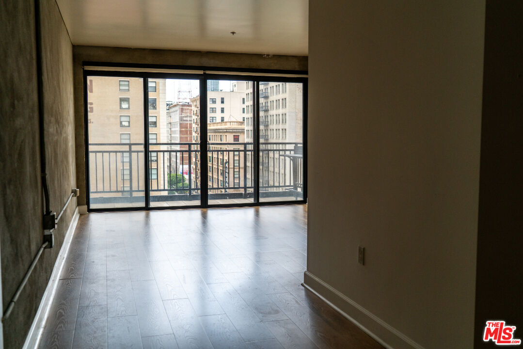 416 South Spring Street, Unit 906 Los Angeles, CA 90013 - Photo 2 of 18 a view of empty room with wooden floor and fan