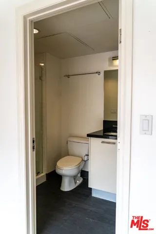 a bathroom with a toilet a sink and a mirror