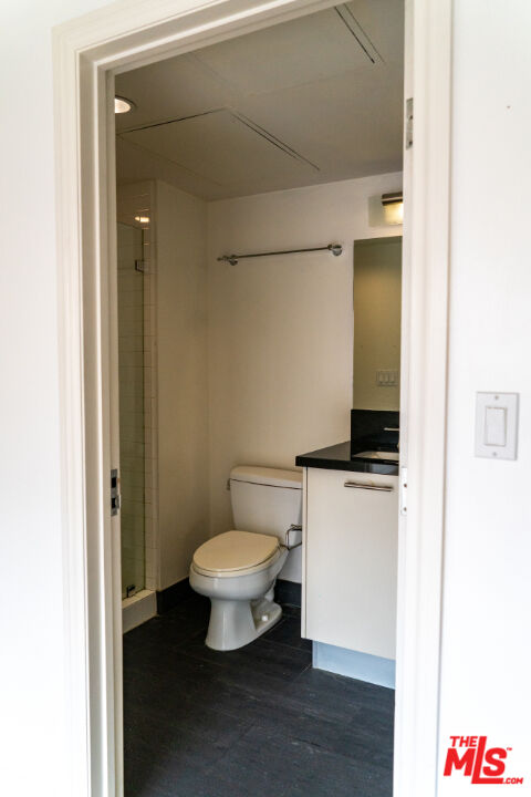 416 South Spring Street, Unit 906 Los Angeles, CA 90013 - Photo 6 of 18 a bathroom with a toilet a sink and a mirror