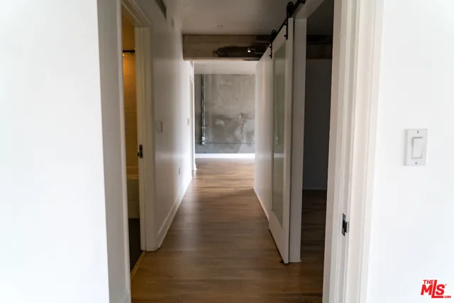 a view of a hallway with wooden floor