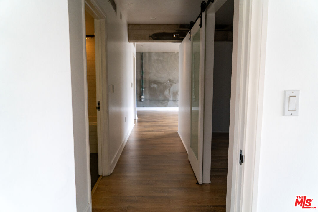 416 South Spring Street, Unit 906 Los Angeles, CA 90013 - Photo 8 of 18 a view of a hallway with wooden floor