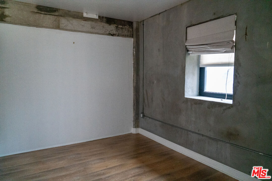 416 South Spring Street, Unit 906 Los Angeles, CA 90013 - Photo 10 of 18 a view of a small space with wooden floor and a window