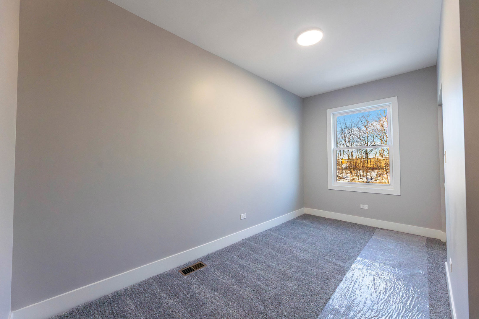 5552 South Shields Avenue Chicago, IL 60621 - Photo 16 of 33 an empty room with wooden floor and windows