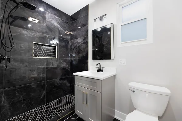 a bathroom with a toilet sink and shower