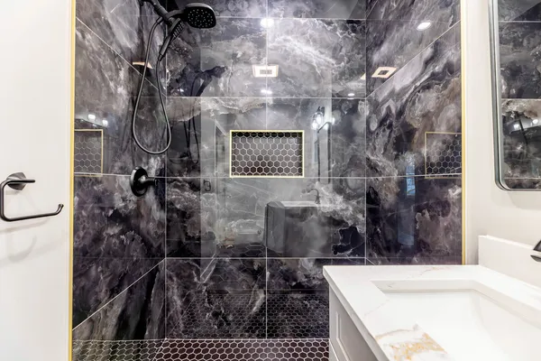 a bathroom with a bathtub and shower