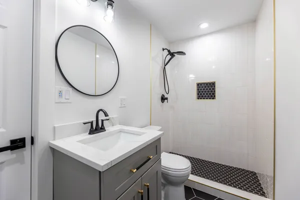 a bathroom with a sink toilet and a mirror