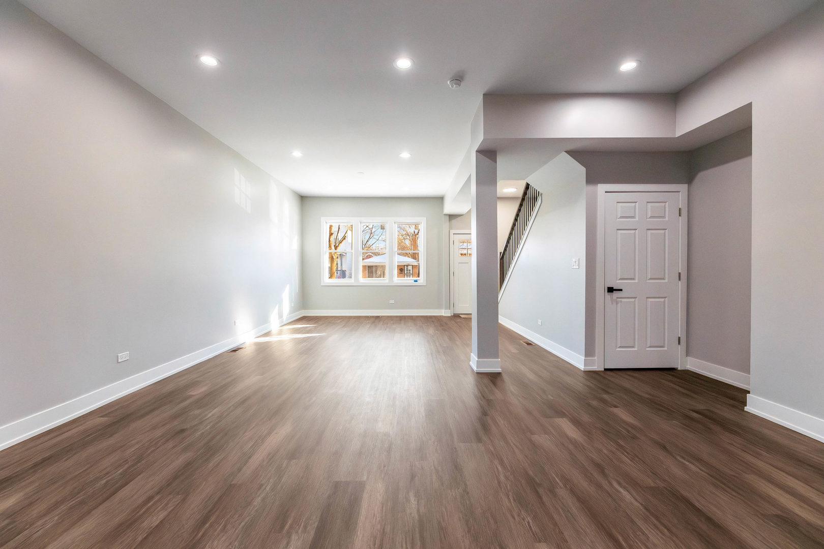 5552 South Shields Avenue Chicago, IL 60621 - Photo 6 of 33 an empty room with wooden floor and windows