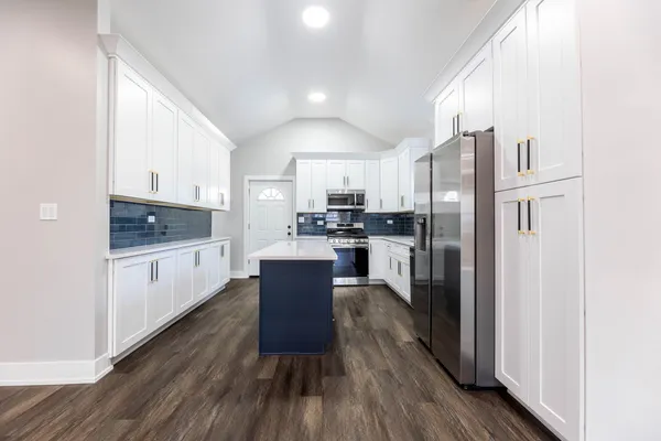 a kitchen with stainless steel appliances a refrigerator stove microwave and cabinets