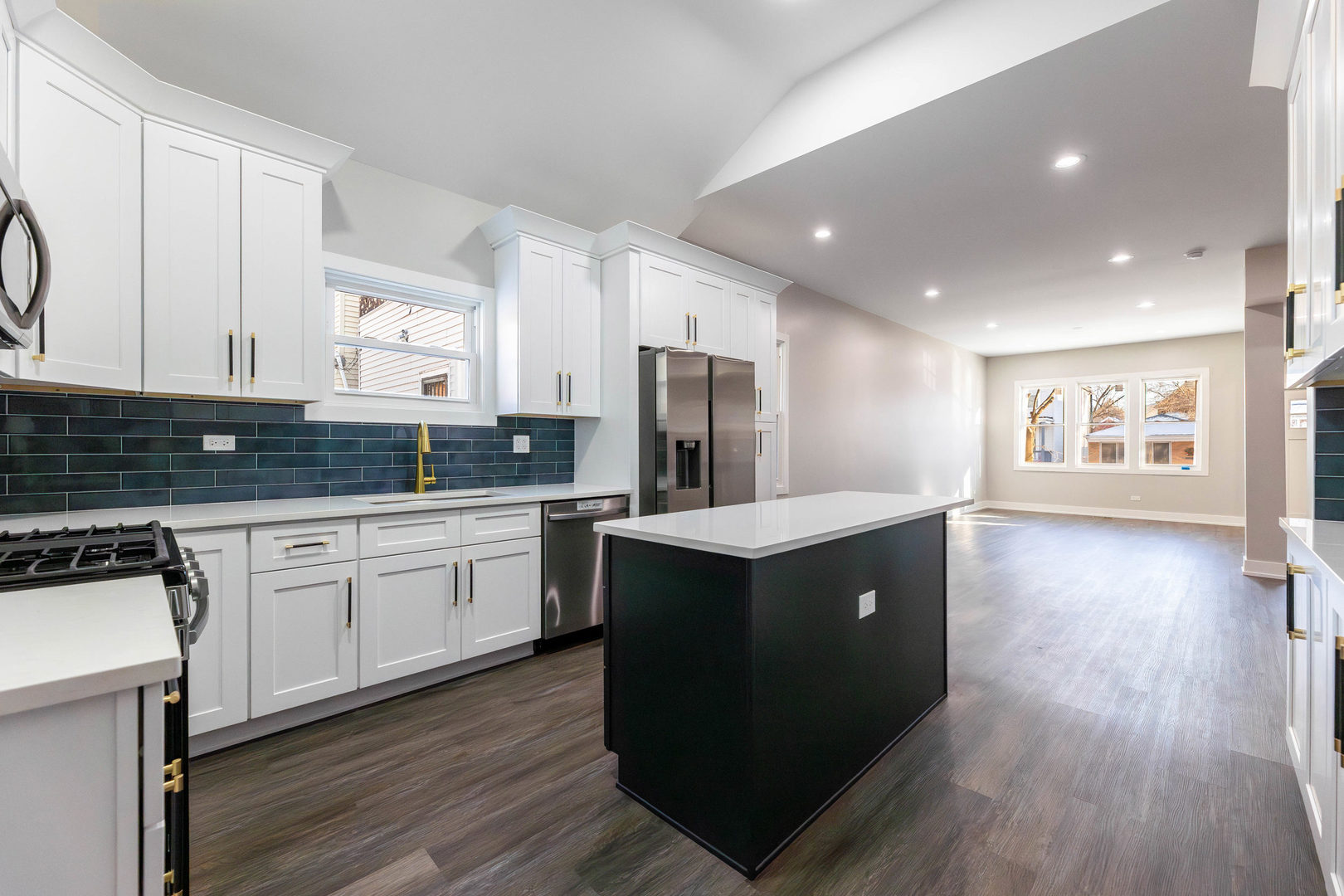 5552 South Shields Avenue Chicago, IL 60621 - Photo 10 of 33 a kitchen with stainless steel appliances granite countertop wooden cabinets a sink a stove a refrigerator and wooden floors