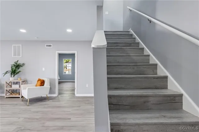 a view of entryway and hall with wooden floor