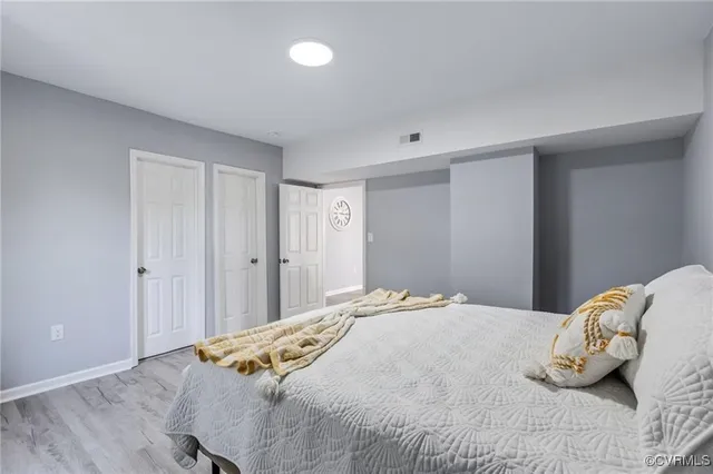a bedroom with a bed and hallway