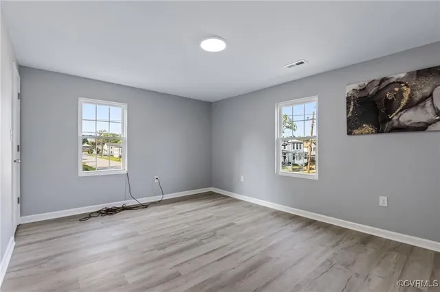 wooden floor in an empty room with a window