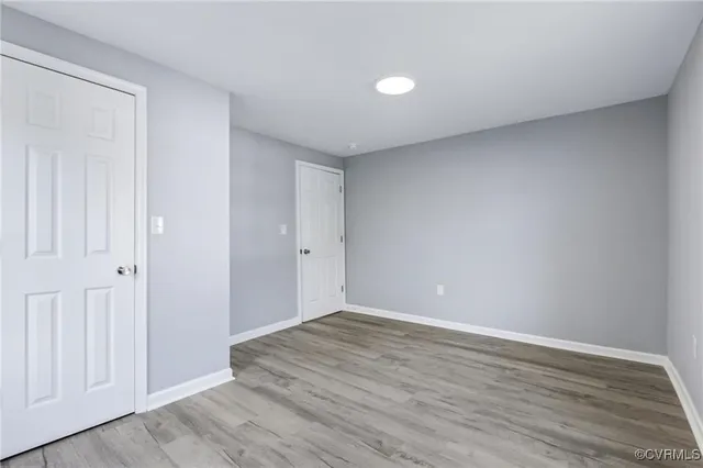 a view of an empty room and wooden floor
