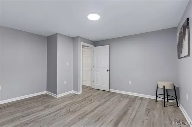 a view of an empty room and wooden floor