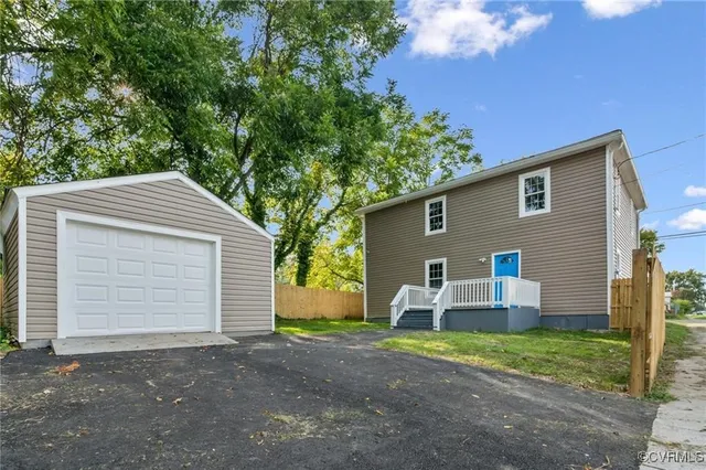 a front view of house with yard and trees