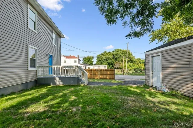 a view of a house with a yard and sitting area