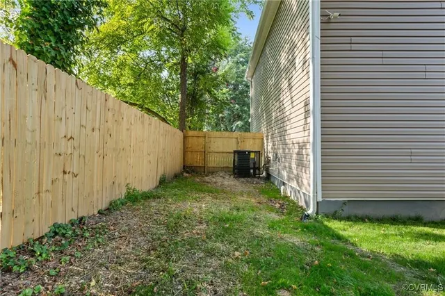 a view of backyard with potted plants and a chair