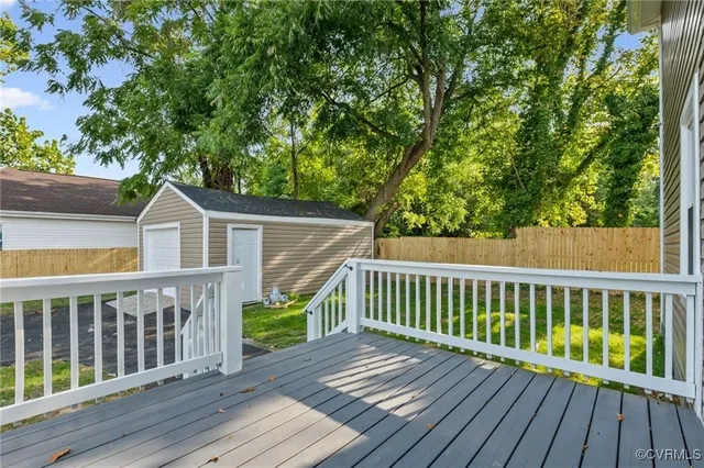 a view of wooden deck and a backyard