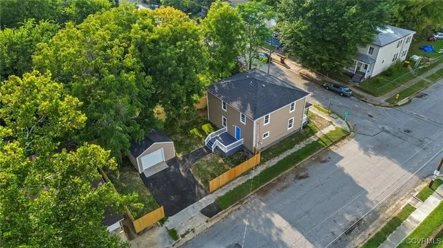 an aerial view of a house with a yard