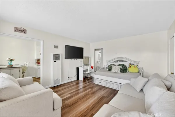 a kitchen with a refrigerator and white cabinets