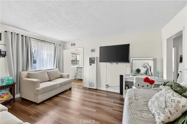 a bedroom with a bed and a wooden floor