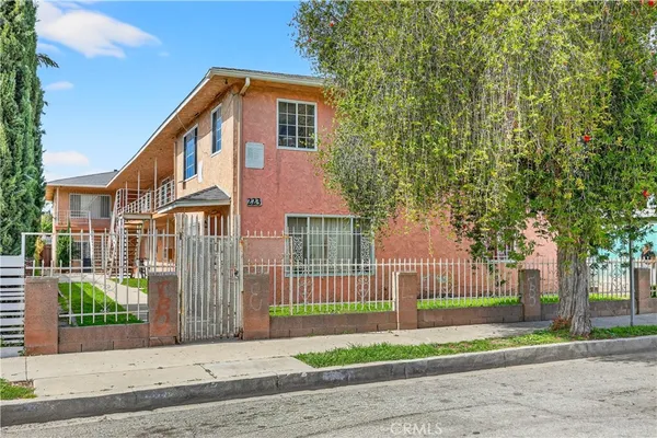 a front view of a house with a garden and plants