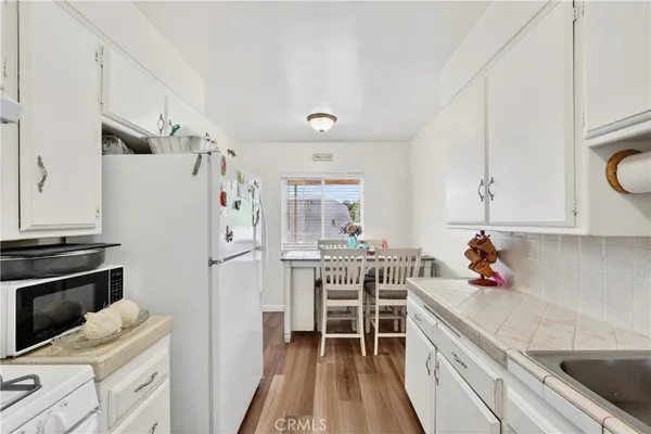 a room with wooden floor and flat screen tv