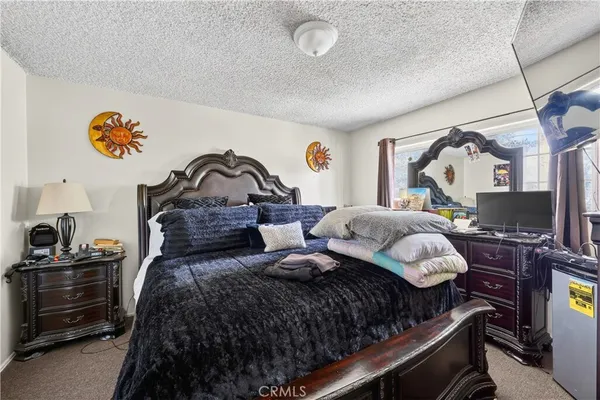 a kitchen with stainless steel appliances a stove refrigerator sink and a potted plant