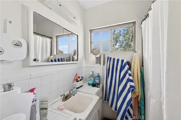 a kitchen with stainless steel appliances granite countertop a sink dishwasher cabinets and couches with wooden floor