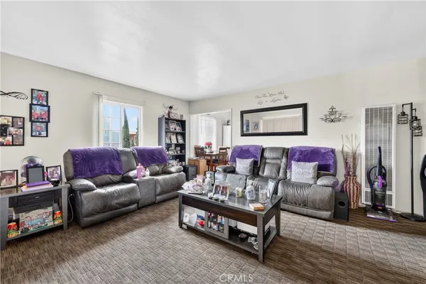 a living room with furniture a couch and a flat screen tv