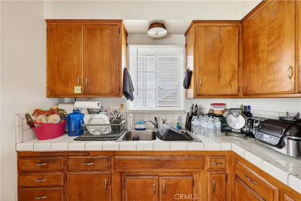 a bedroom with a bed dresser and a potted plant