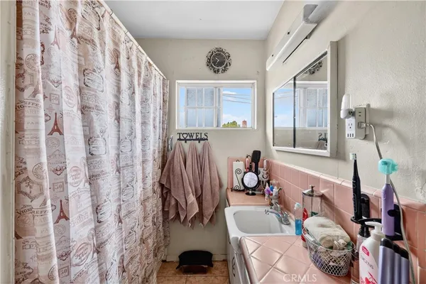 a bedroom with furniture and a window