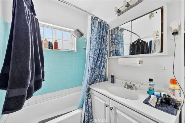 a view of a house with a yard and a large tree