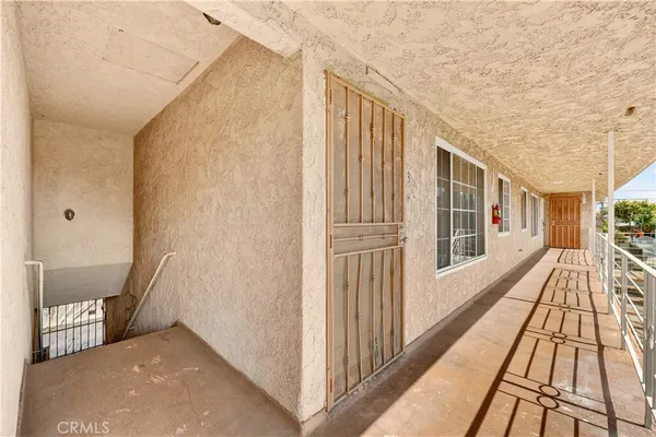 a living room with furniture a flat screen tv and a couch