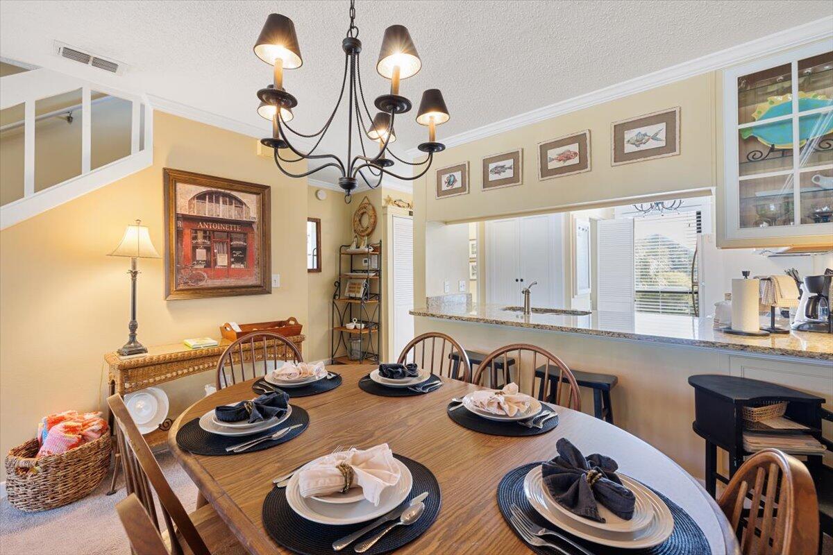 255 Pelican Circle, Unit 3 Inlet Beach, FL 32461 - Photo 14 of 38 a table and chairs in a kitchen