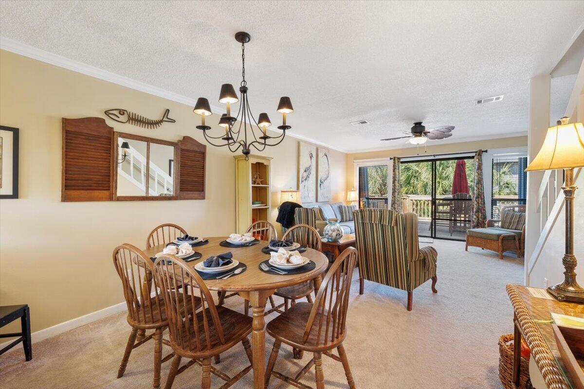 255 Pelican Circle, Unit 3 Inlet Beach, FL 32461 - Photo 15 of 38 a view of a dining room with furniture and a chandelier