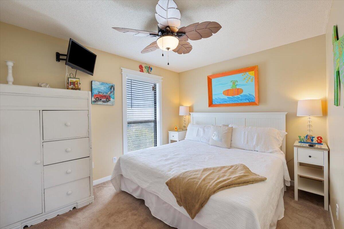 255 Pelican Circle, Unit 3 Inlet Beach, FL 32461 - Photo 22 of 38 a bedroom with a bed and a flat screen tv