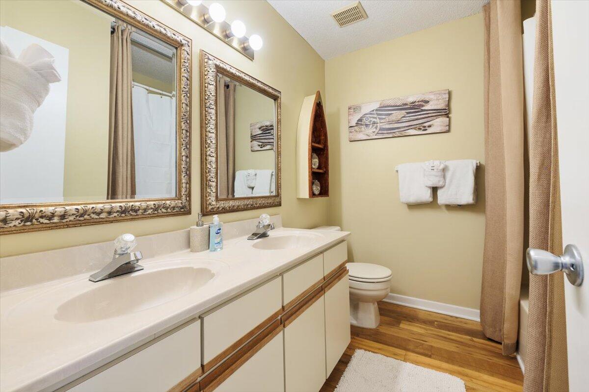 255 Pelican Circle, Unit 3 Inlet Beach, FL 32461 - Photo 23 of 38 a bathroom with a sink a toilet and mirror