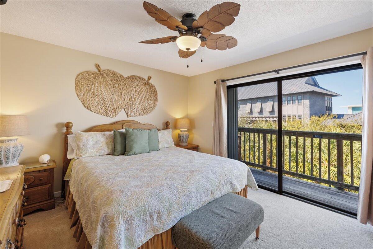 255 Pelican Circle, Unit 3 Inlet Beach, FL 32461 - Photo 24 of 38 a bedroom with a large bed and a chandelier