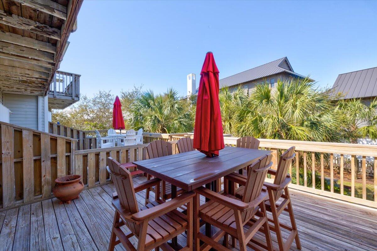255 Pelican Circle, Unit 3 Inlet Beach, FL 32461 - Photo 28 of 38 a view of a dining table and chairs on the roof deck