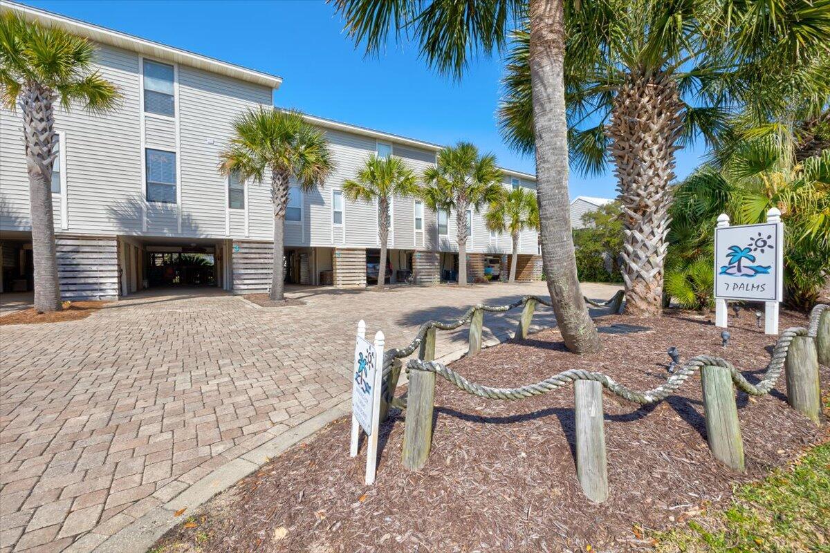255 Pelican Circle, Unit 3 Inlet Beach, FL 32461 - Photo 4 of 38 a view of a patio with table and chairs potted plants and palm tree