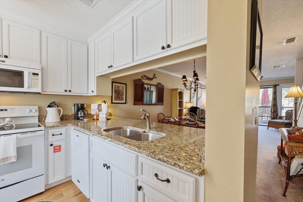 255 Pelican Circle, Unit 3 Inlet Beach, FL 32461 - Photo 8 of 38 a kitchen with sink cabinets and appliances