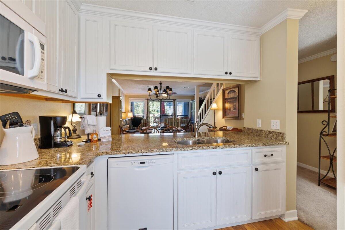 255 Pelican Circle, Unit 3 Inlet Beach, FL 32461 - Photo 9 of 38 a kitchen with stainless steel appliances granite countertop a sink and cabinets